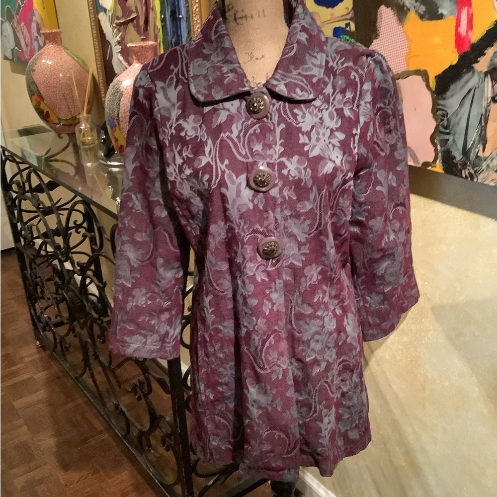 Floral print Ja with large decorative buttons.